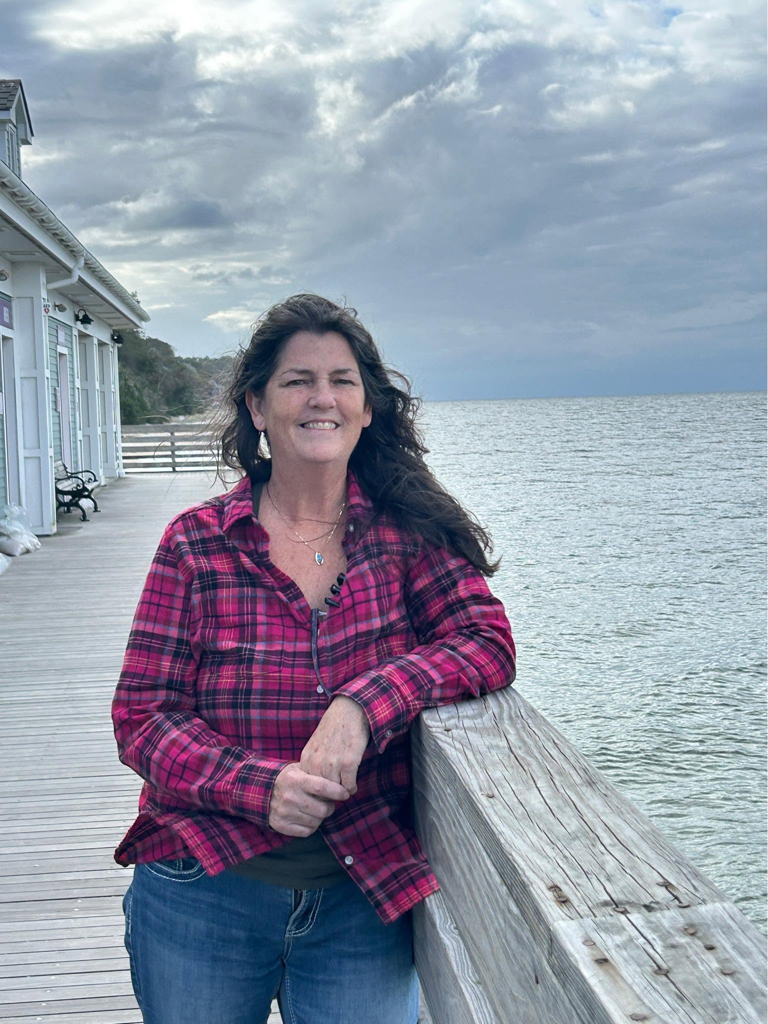 Eileen smiling on the coastal boardwalk